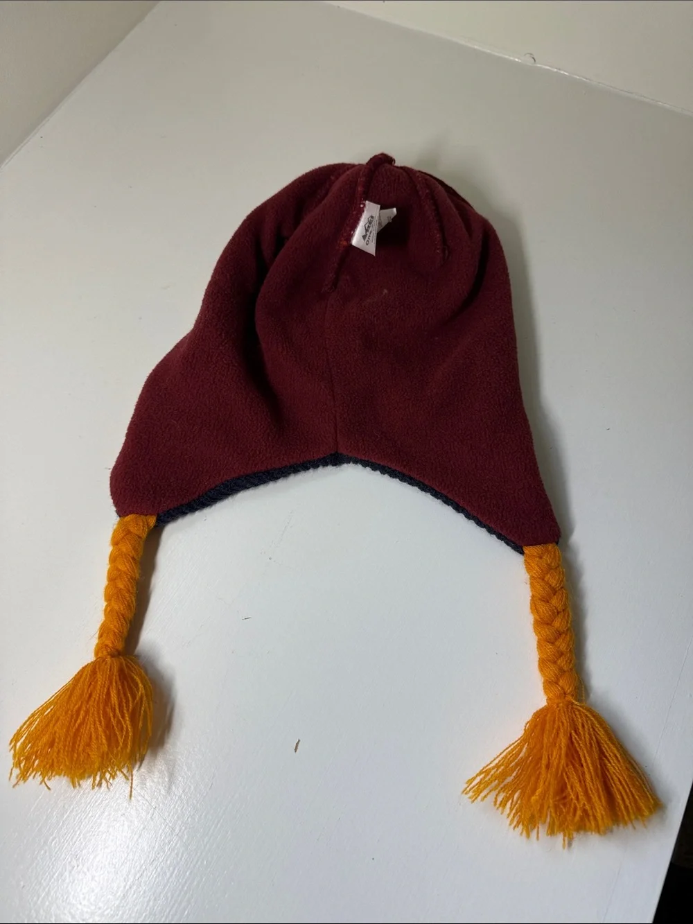 Kids REI acrylic knit beanie hat with pompom and ear flaps.